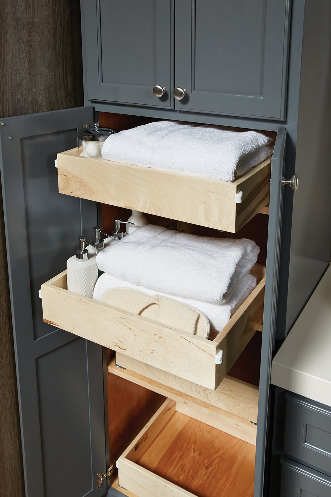 concealed drawers behind the doors of a bathroom linen cabinet