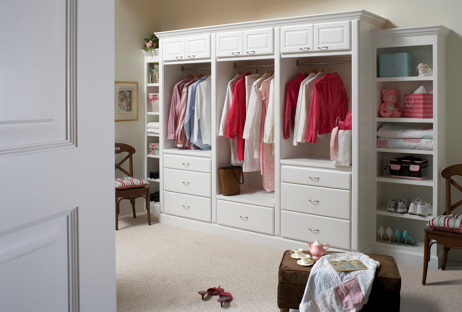 white cabinet with space for hanging clothes and drawers for storage