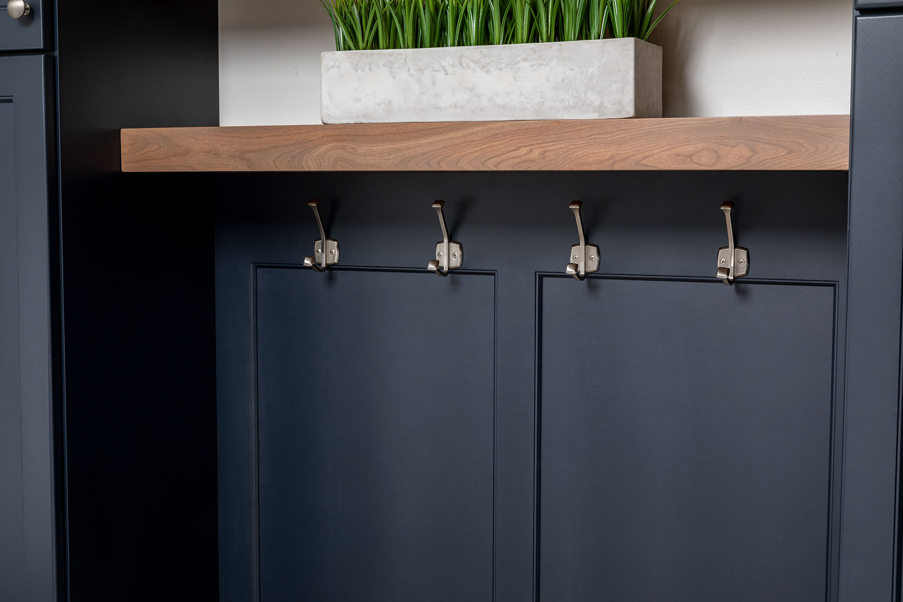 Dark blue cabinets create a drop zone