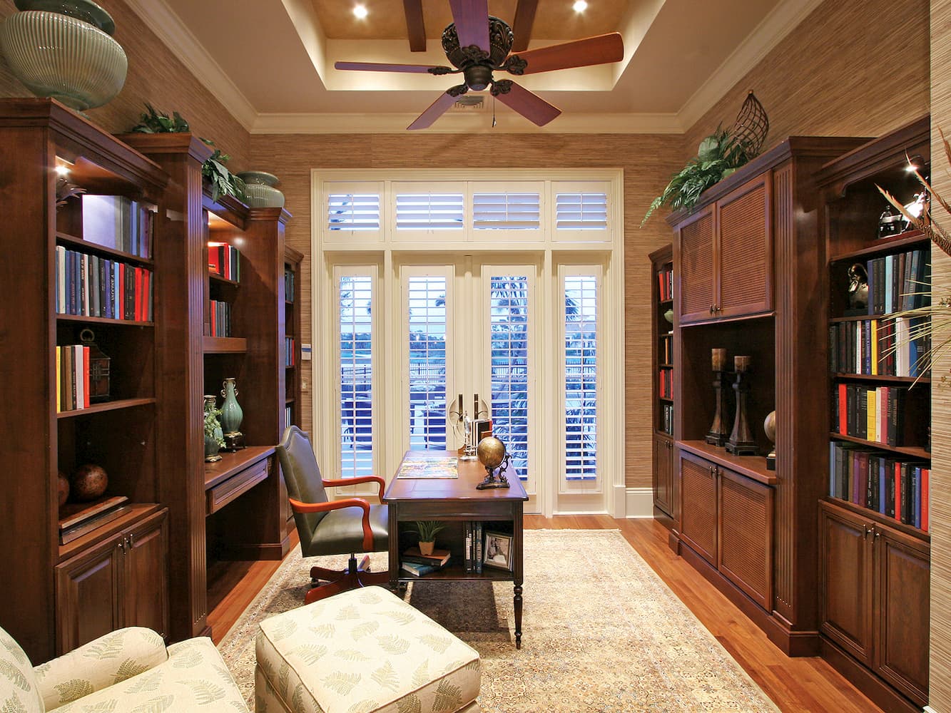 elegant home office study space with a desk and cabinets with shelves