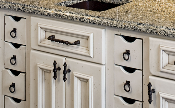 Small pull out drawers featured under a bar sink