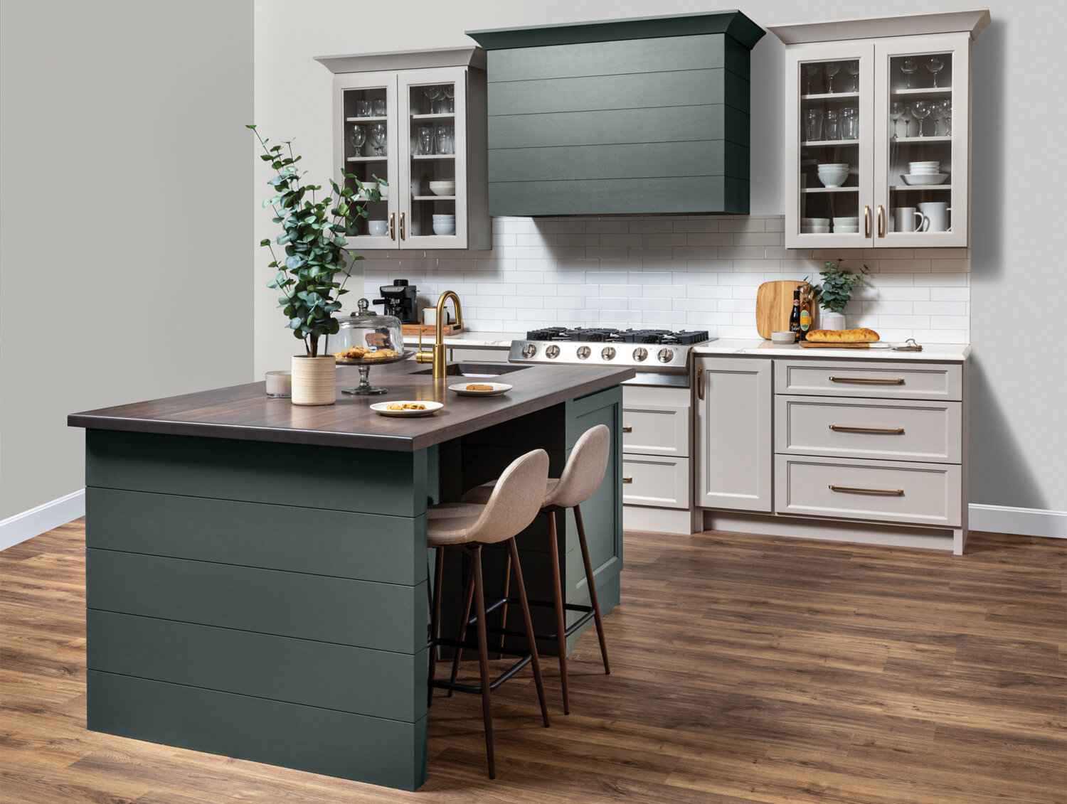 A kitchen with a modern wood hood with shiplap details and a hunter green painted finish surrounded by off-white, light gray cabinets with a dramatic flat panel door style.