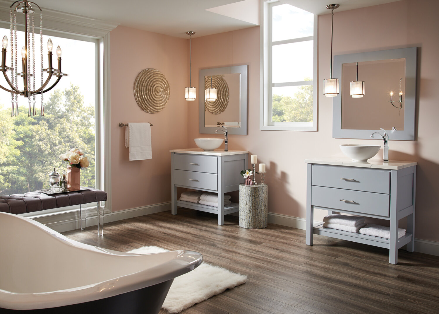 A light gray-blue dual furniture vanities and matching framed mirrors with open shelves below in a chic master bath.