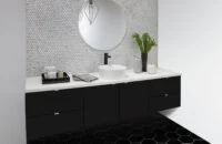 A black and white, moody bathroom design with a contemporary floating vanity in black paint.
