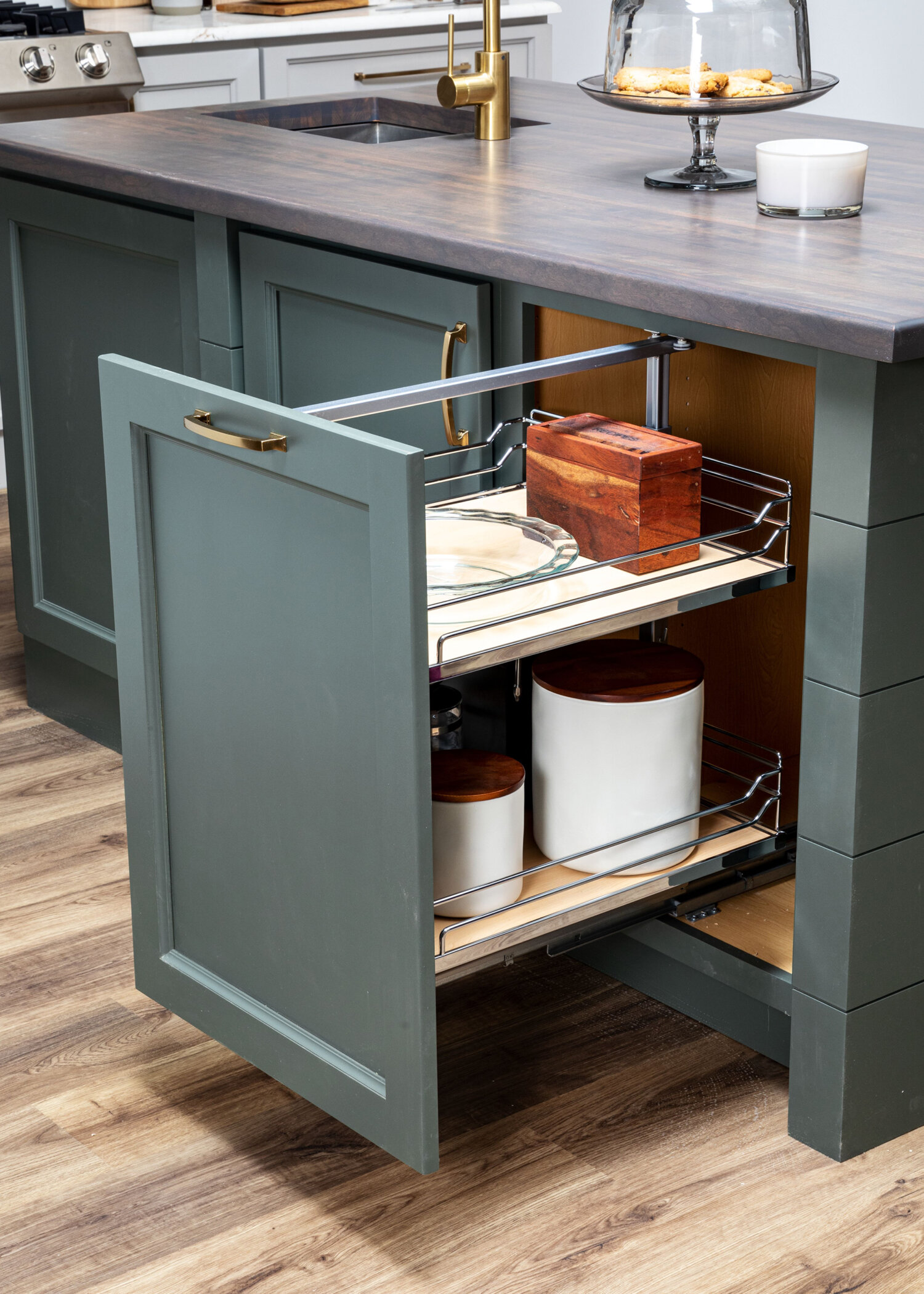 A pull-out under-the-counter storage cabinet from Bertch that features sleek, chrome rails works great for pantry & misc. kitchen storage.