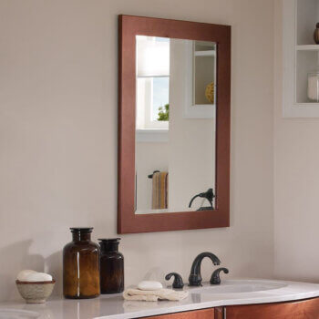 A wood framed mirror customized to match the vanity details and finish.