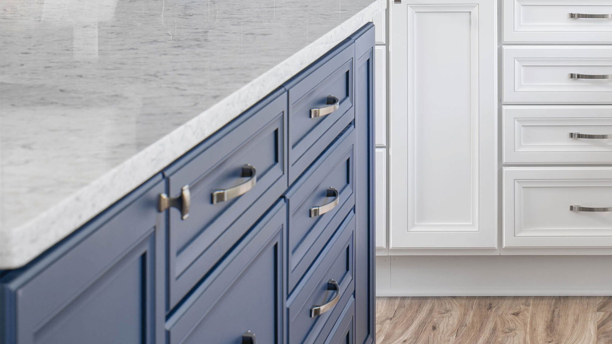 A close up of dark navy blue painted kitchen island cabinets.