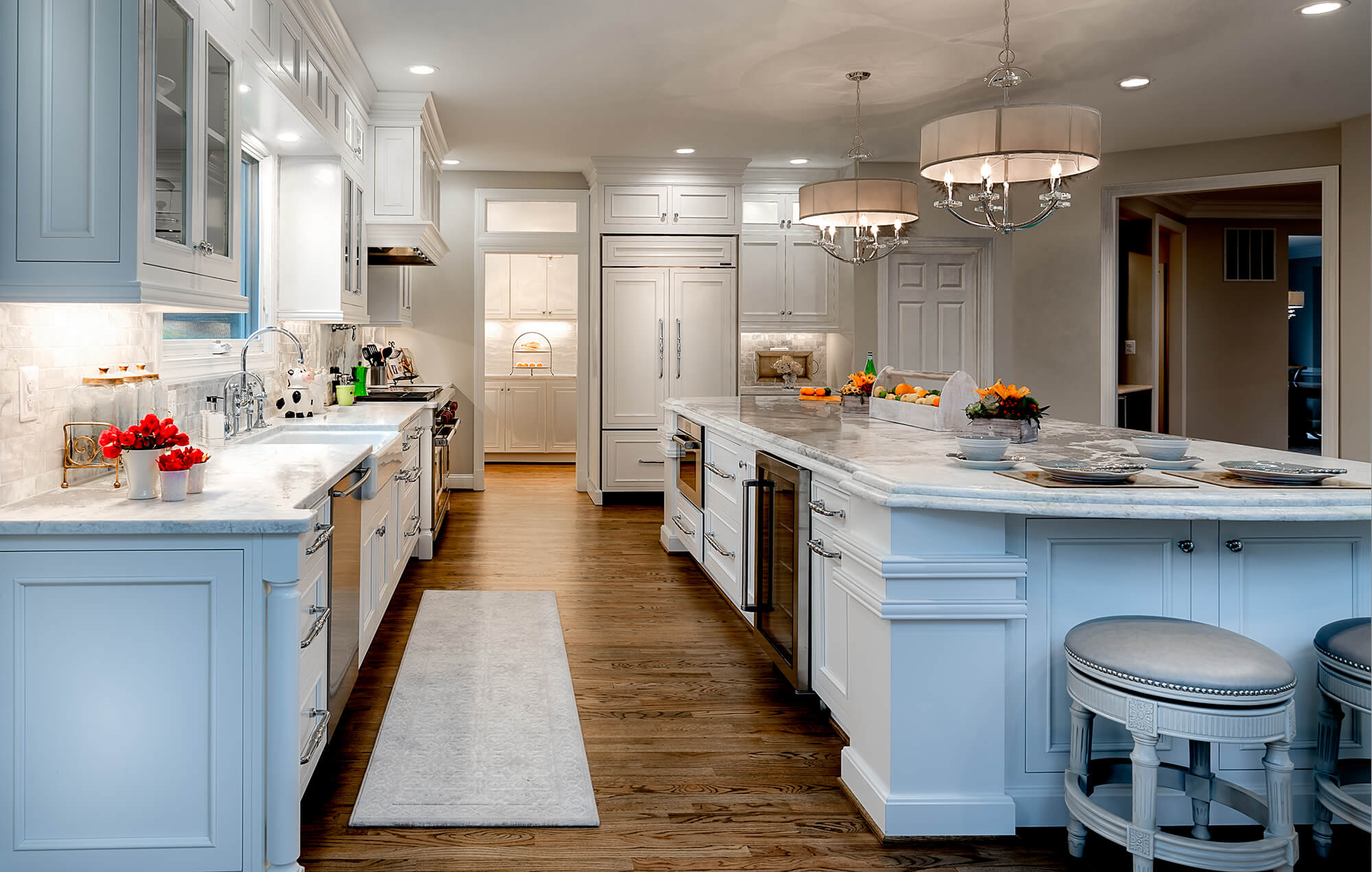 Beautiful white kitchen with a large scale kitchen island.