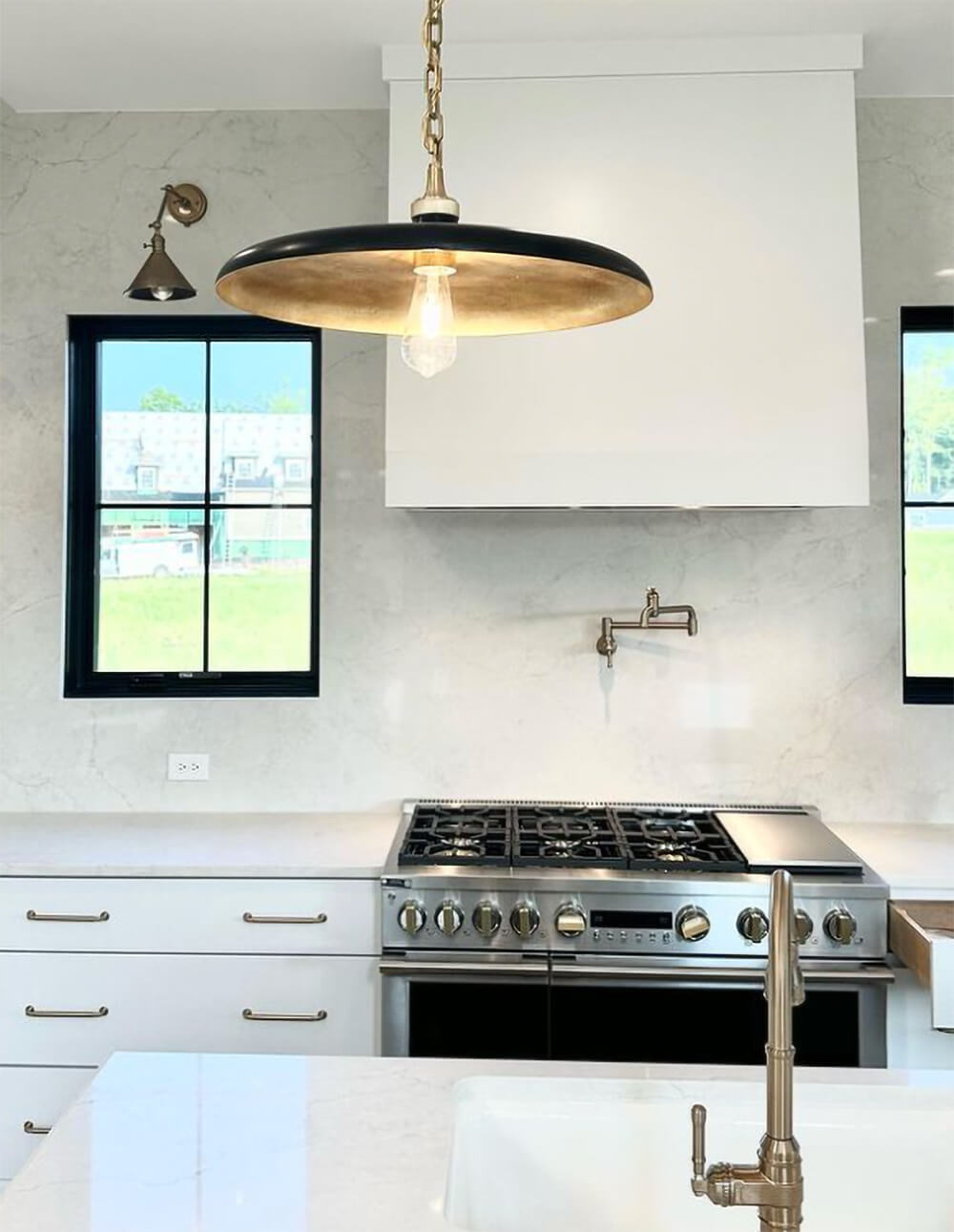 Marble slab backsplash from counter to ceiling.