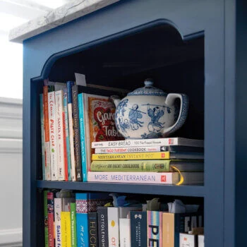 The Arched Valance from Bertch can be used as a valance or as a decorative toe. Shown here as a valance detail on a kitchen island book end.