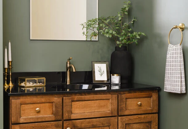 Bertch Edgewood vanity in Kodiak stain, with black legs and cozy green walls