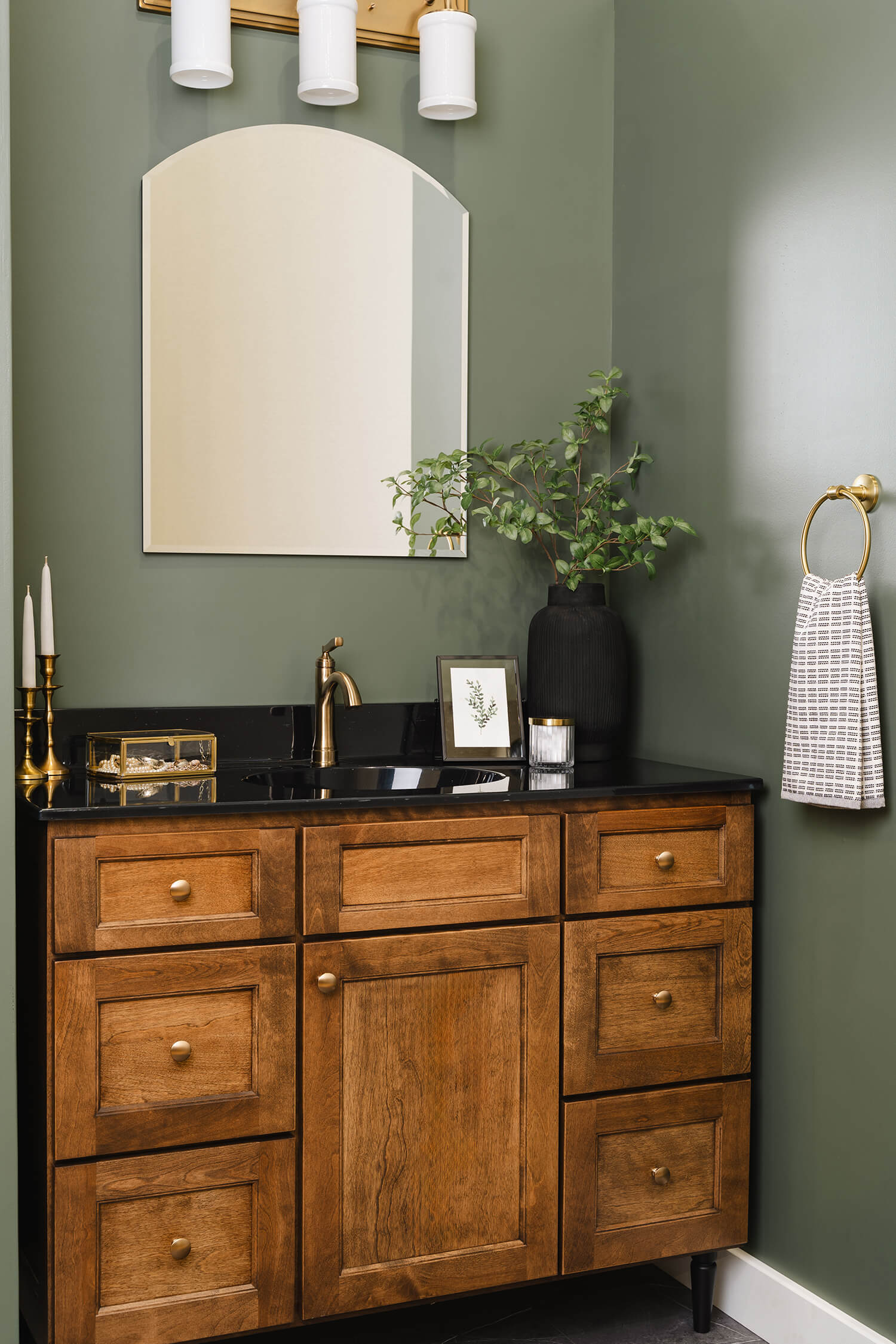 Bertch Edgewood vanity in Kodiak stain, with black legs and cozy green walls