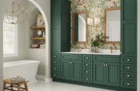 Beautiful rich green Bertch Bath cabinetry with bold floral wallpaper