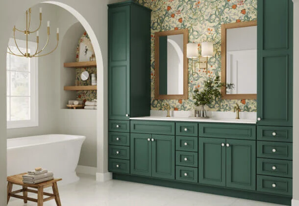 Beautiful rich green Bertch Bath cabinetry with bold floral wallpaper