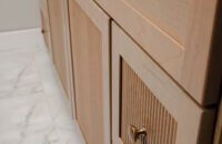 Bertch's much anticipated reeded door style, Reedlyn, shown in Cashew stain on Cherry wood.