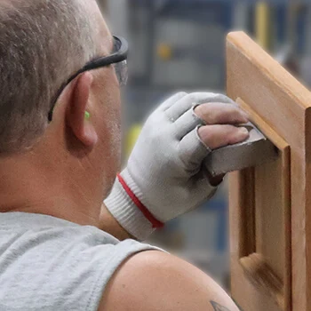 Bertch associate hand-sanding fine details
