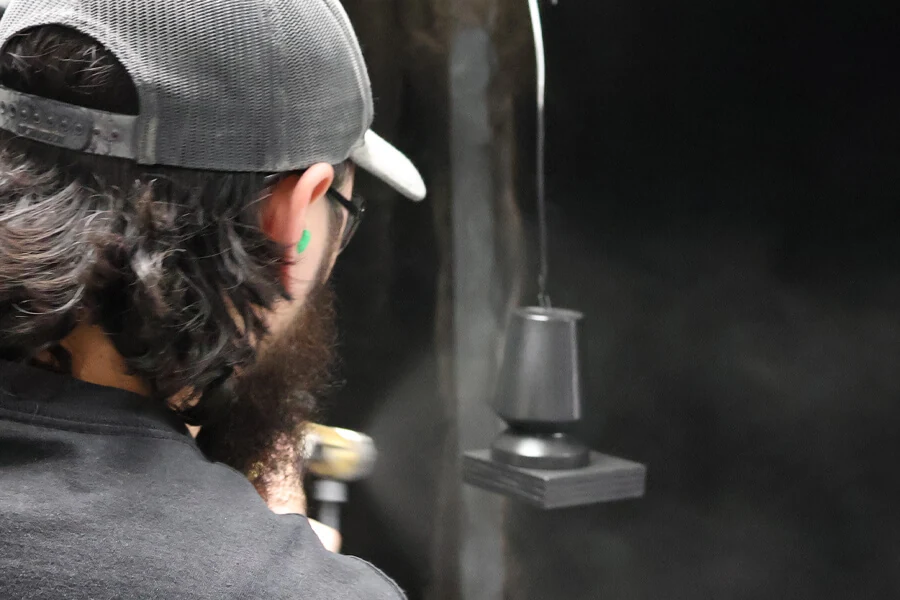 Bertch associate spraying a wood leg